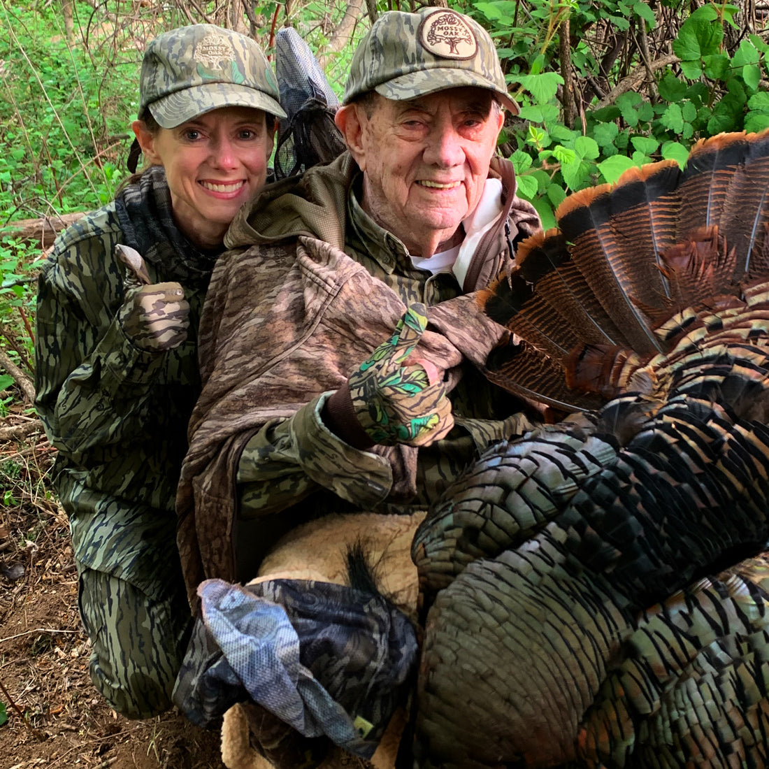 Portrait of Laura and her father Tom Kelly, in camouflage attire on a turkey hunt.